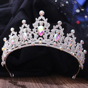 Detailed macro view of silver bridal crown featuring colorful rhinestones and teardrop crystal