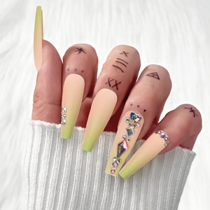 Macro detail of long coffin nails with matte gradient finish and colorful rhinestones