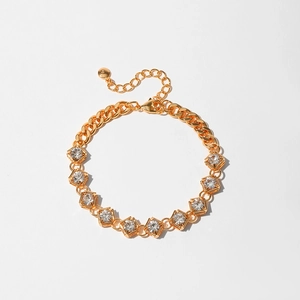 Detail of gold-plated bracelet featuring geometric square zircon stones and cuban links