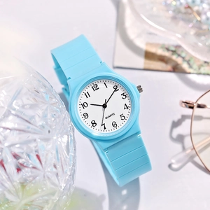 Close-up of sky blue quartz watch with white dial and clear Arabic numerals