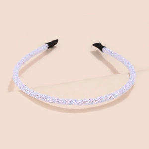 Detail shot of white glitter headband with shimmering sequins and black tip protection