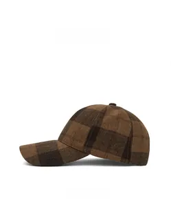 Side view detail of a brown plaid wool baseball cap showing classic vintage texture