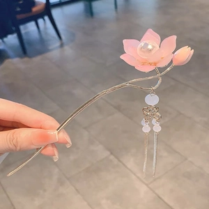 Close-up of glowing pink lotus hair pin with silver tassels and pearls for Hanfu style