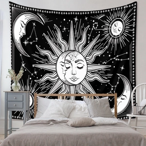 Detail of bohemian mandala tapestry featuring sun and moon astrology theme on a wall