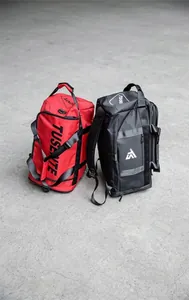 Detail of red and black Oxford cloth travel backpacks with side brand logo print