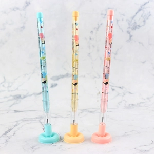 Detailed view of three stackable pencils with suction bases in blue yellow and pink