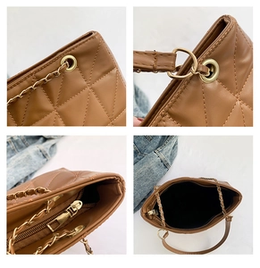Close-up of brown quilted PU leather bag featuring gold chain and hardware details