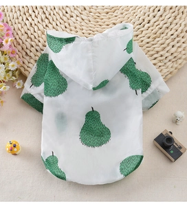 Detail of white hooded pet sun protection shirt with green pear patterns and breathable fabric