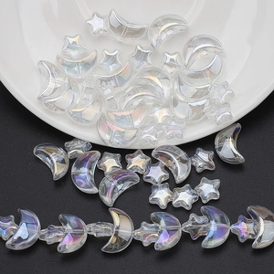 Detailed view of iridescent moon and star glass beads for DIY jewelry making sets