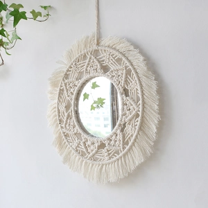 Handmade macrame wall hanging mirror with white fringe and round woven geometric design