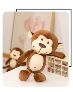 Close-up of cute brown plush monkey doll with soft fur and stitched belly detail