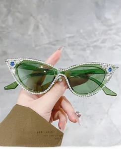 Detail of cat-eye glasses frame featuring hand-set crystals and blue gemstone accents