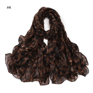 Detail view of lightweight leopard print scarf with fine stitching and soft fabric texture