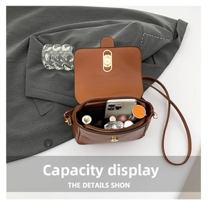 Interior view of brown leather crossbody bag showing capacity for phone and lipstick