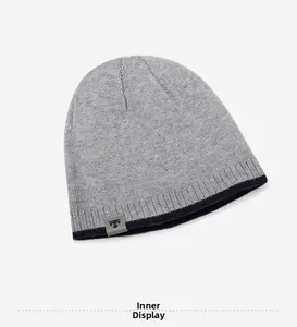 Detailed interior display showing warm grey knit texture and blue edge of the beanie