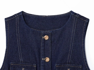 Detail of dark blue denim vest with round neckline, gold buttons and yellow contrast stitching