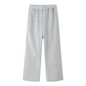 Detailed flat lay of light grey knitted wide-leg sweatpants with elastic waist on white background