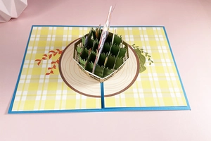 Macro shot of 3D Easter pop-up card featuring a brown rabbit basket on grass base