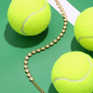 Close-up of gold-plated stainless steel tennis bracelet with sparkling zircon stones