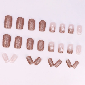 Glittery French press-on nails with rose gold sequins and heart patterns in 24 piece set