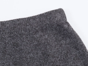 Detail shot of dark gray knit fabric showing the texture and premium waist seam quality