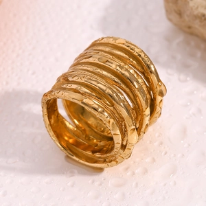 Close-up of 18K gold plated multi-layer spiral ring with textured molten metal finish