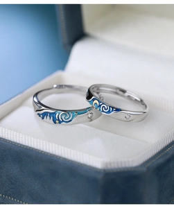 Macro shot of S925 sterling silver Van Gogh Starry Night couple rings with blue enamel