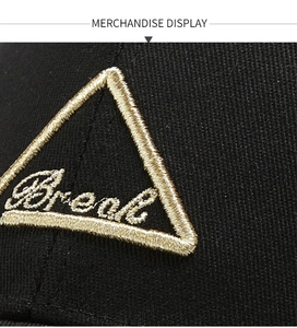 Macro shot of 3D triangle embroidery detail on black twill cotton baseball cap