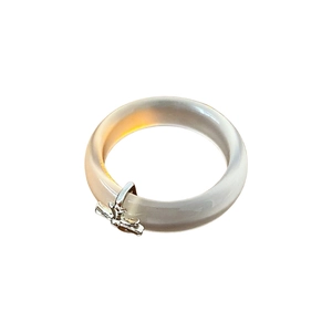 Modern grey chalcedony ring with silver metal cross pendant on white background