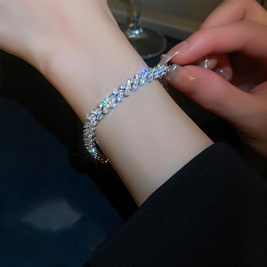 Close-up of sparkling multi-row zircon bracelet with silver metal on a woman wrist