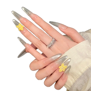 Extra long stiletto press-on nails with silver cat-eye gradient and yellow 3D floral accent