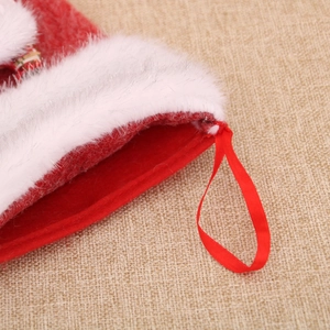 Close-up of plush white cuff and red felt Christmas stocking with hanging loop