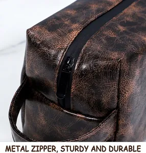 Close-up of durable metal zipper and dark brown textured PU leather of the toiletry bag