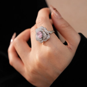 Detail of flower ring with pink oval zircon and pavé micro-diamonds on silver band
