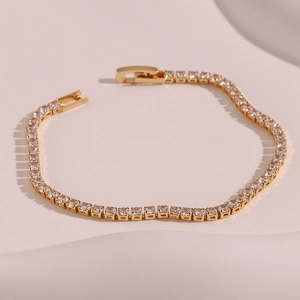 Detailed macro view of 14K gold plated tennis bracelet with sparkling zircon stones