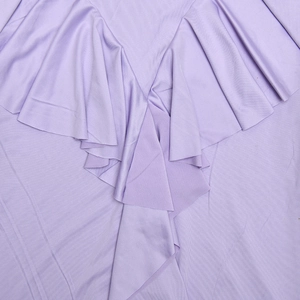 Detailed view of light purple dress fabric featuring soft ruffled layers and smooth texture