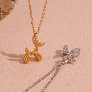 Balloon dog pendant necklace in 18K gold and silver finishes with polished mirror surface