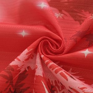 Close-up of red Christmas curtain fabric with white stars and elk patterns