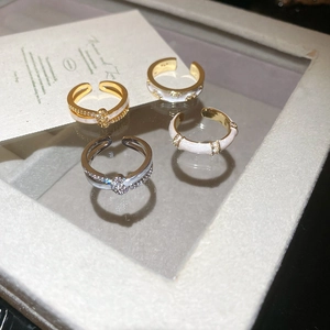 Detailed close-up of 18k gold plated double layer crossover rings with zircon stones