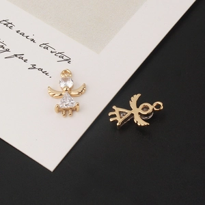 Macro shot of gold-plated angel charms with micro-pave cubic zirconia for DIY jewelry