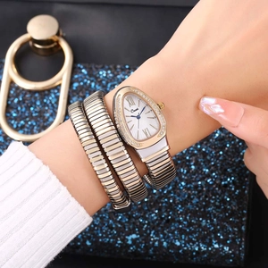 Close-up of a snake-shaped quartz bracelet watch with sparkling rhinestones on the wrist