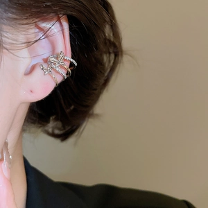Close-up of sparkling zircon butterfly multi-layer ear cuff on a female ear