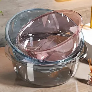 Set of three stackable transparent plastic washbasins in clear, blue, and purple tones