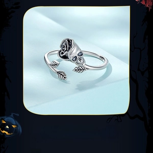 Detailed macro view of S925 sterling silver skull and rose ring on blue satin