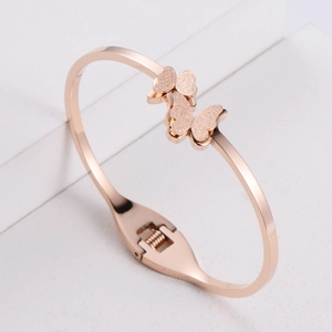 Minimalist rose gold butterfly bangle in titanium steel with spring open design