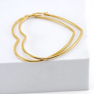 Minimalist large heart shaped gold hoop earrings in polished stainless steel for women