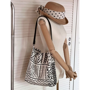 Close-up of bohemian canvas tote bag showing black geometric patterns and wide shoulder strap