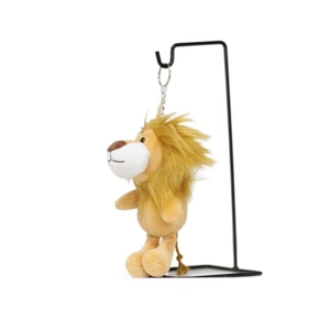 Cute lion plush keychain toy with yellow mane hanging on a display stand for bags