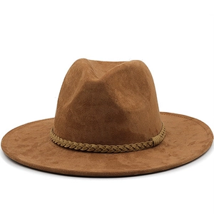 Close-up of brown suede wide brim cowboy hat featuring a braided decorative band detail