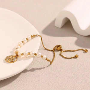 Close-up of 18K gold plated pearl bracelet with zircon shell pendant and adjustable slide clasp